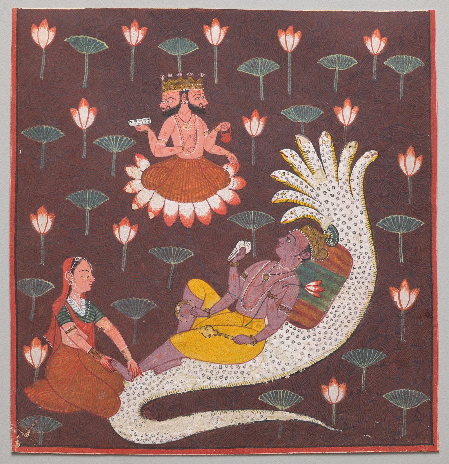 A small square Indian painting on a deep maroon ground patterned like basket weave. A blue-skinned god in a yellow wrap reclines on the coils of a white many-headed serpent whose hoods arch over him; he holds a conch and a lotus. A woman in a red sari kneels at his feet with her hands on them. From his navel a pink lotus rises, and on it sits a small four-headed figure. Pink lotus blooms and green leaves are scattered across the background.