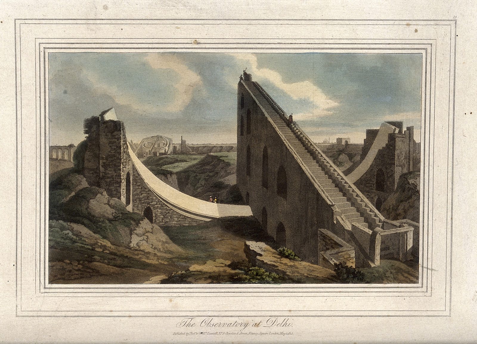 A coloured aquatint of the open-air observatory at Delhi. On the right, a huge triangular masonry ramp rises steeply out of rough ground, with a flight of steps running all the way up its sloping edge and tall arched openings cut into its side; a tiny figure stands at the very top. A long pale curved wall sweeps down from its foot towards the right of the picture, and a second curved wall runs off to the left towards a broken tower, with two small figures in red standing on it. A round latticed structure and the roofs of the distant city sit on the horizon under a cloudy sky. The plate is printed on aged, lightly spotted paper inside ruled borders, with the title written in script beneath it.