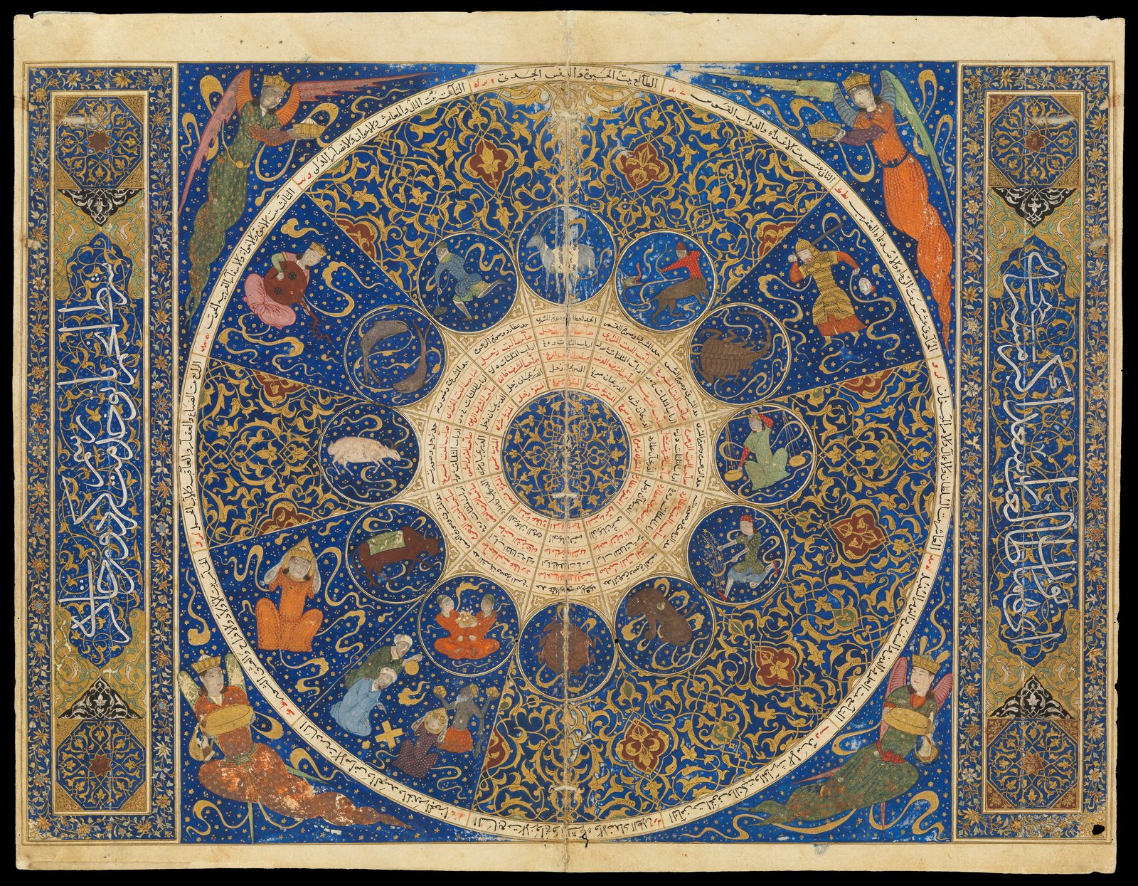 A lavishly illuminated manuscript page. A great circle on a deep lapis-blue ground is divided into twelve segments, each holding a gold-framed roundel painted with a zodiac figure. a ram, a bull, twins, a crab, a lion, a scorpion, a fish. The centre is a dense ring of small red and black Arabic entries around a gold rosette. Crowned winged figures in orange and green occupy the four corners, and panels of white script on blue flank the page.