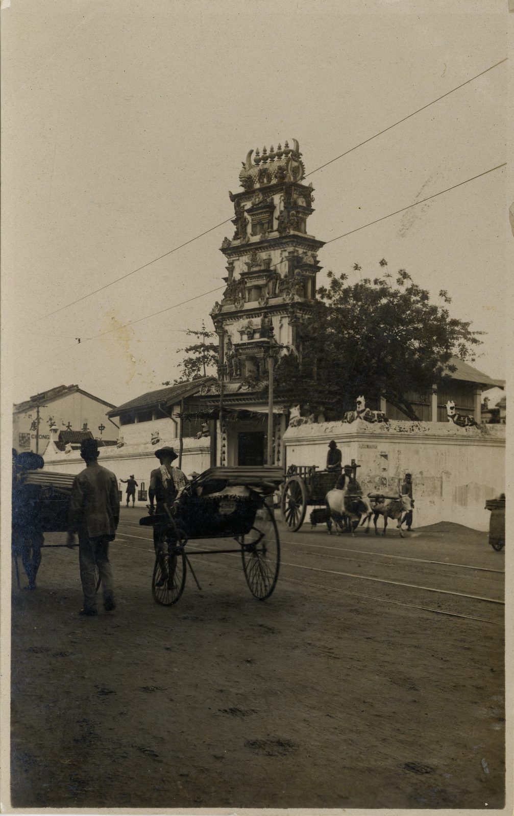 An old picture postcard of a Hindu temple on South Bridge Road in Singapore, photographed between 1895 and 1908. The temple front stands directly on the street, with the low buildings of the road running away on either side.