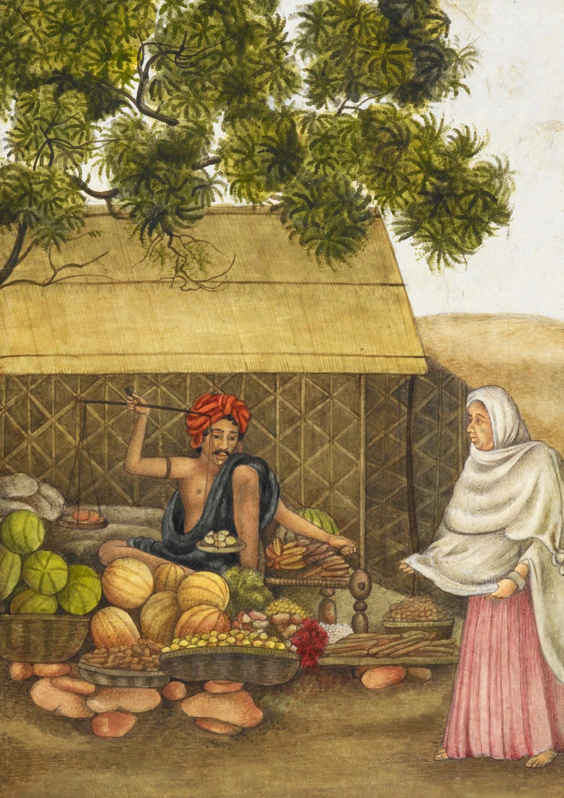 A watercolour on cream paper. A greengrocer sits cross-legged on the ground under a thatched lean-to and a spreading tree, bare-chested with a dark blue cloth over one shoulder and a red turban, holding up a small hand balance by its beam while a round pan of produce hangs from one end. Heaped around him are baskets and trays of melons, gourds, lemons, carrots, nuts and sweet potatoes, and one red flower. At the right a woman wrapped head to knee in white over a pink skirt stands barefoot, waiting, looking at him.