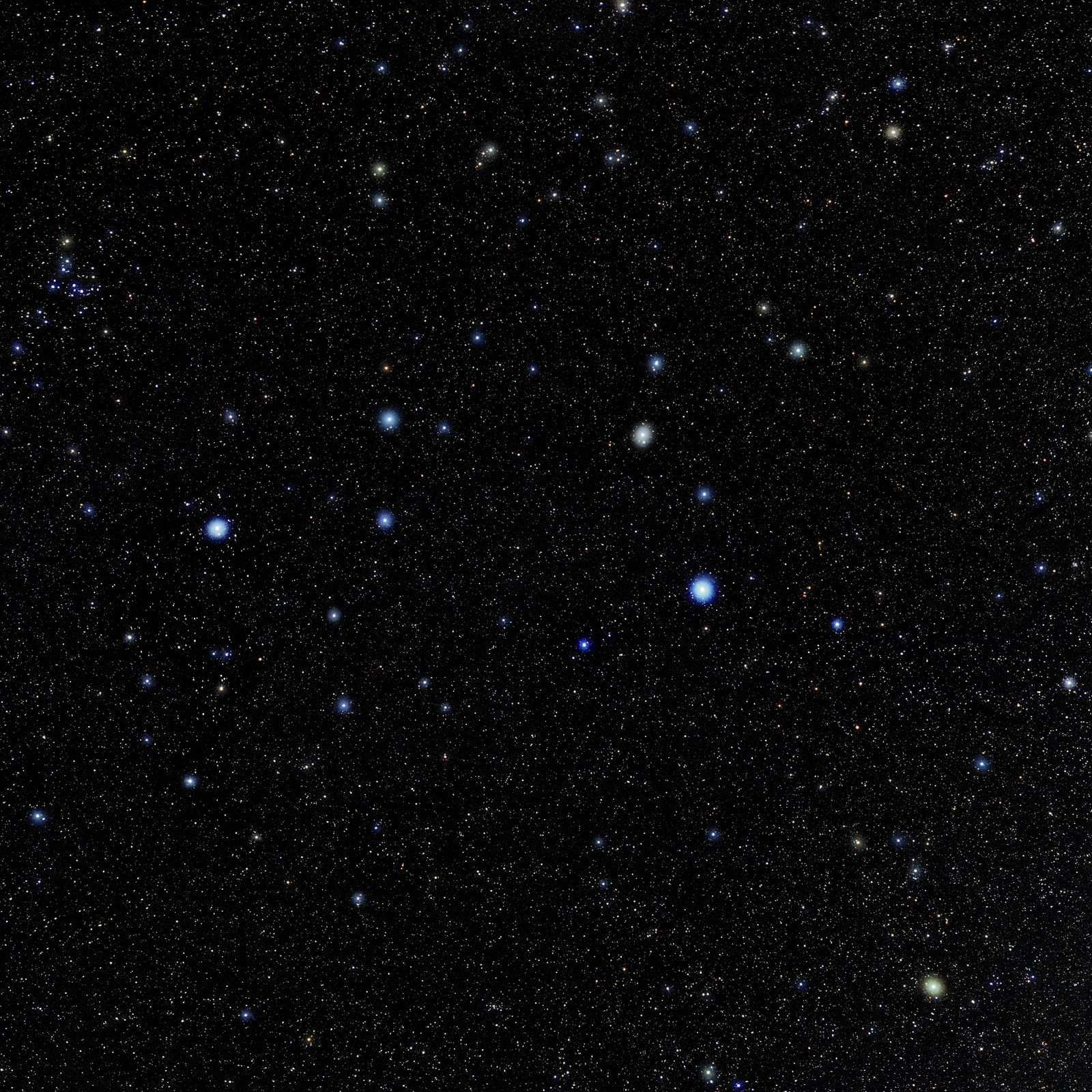 A wide colour photograph of a dense star field on a near-black sky. A bright blue-white star sits low at the right of centre, with a curve of fainter white and amber stars rising above and to the right of it in a hook shape. A second bright star stands at the far left, and thousands of faint pinpoints fill the rest of the frame.